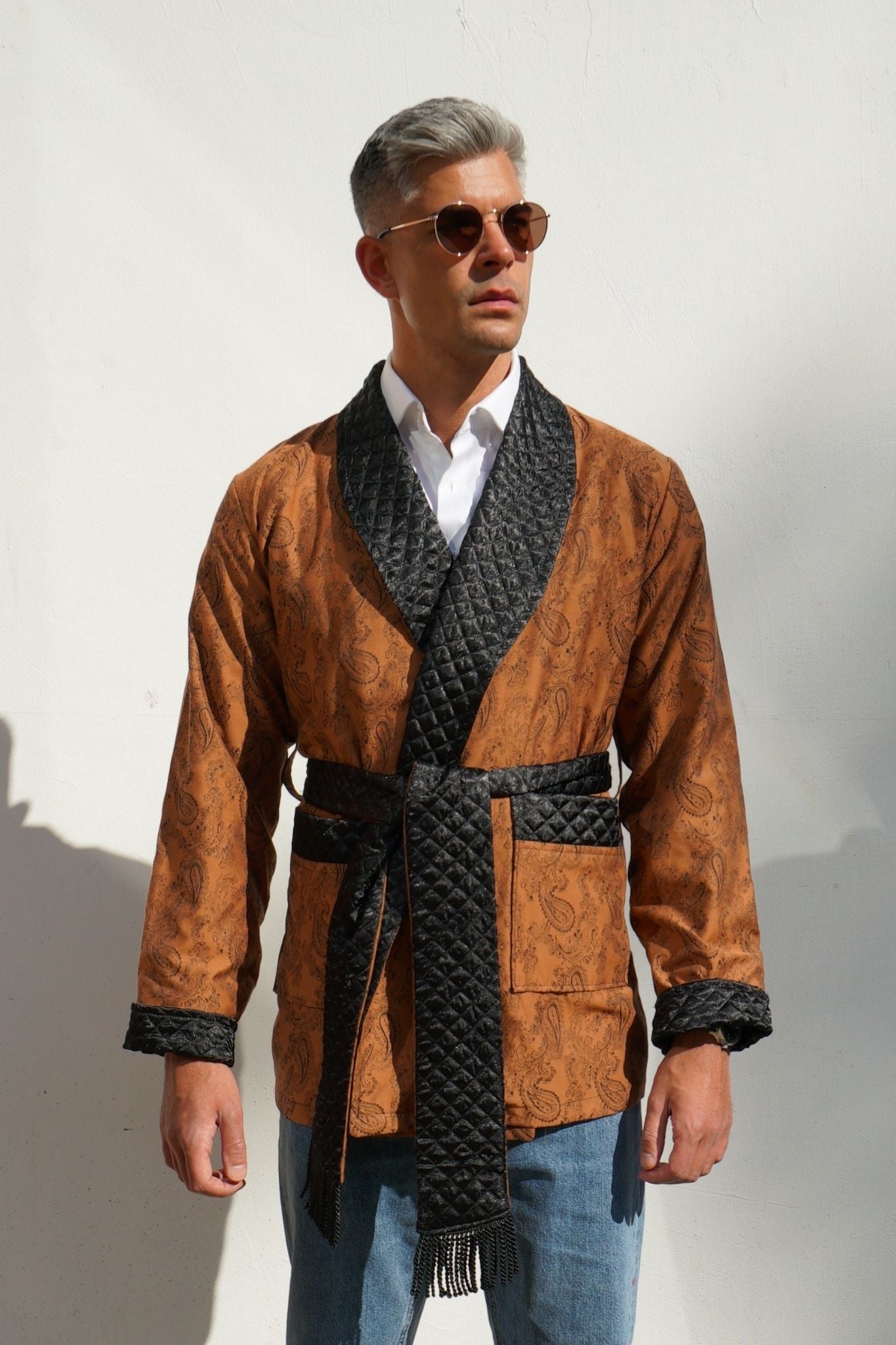 Model wearing Midas men's smoking jacket in gold paisley