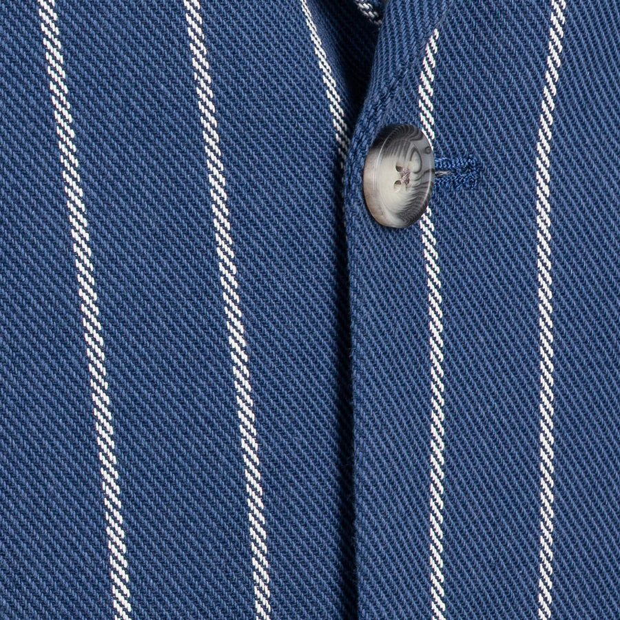 Close-up of a blue and white striped fabric with a button.