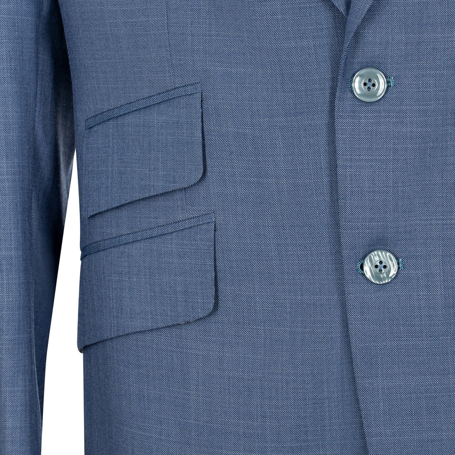 Close-up of a blue suit jacket with two buttons and a pocket on a white background