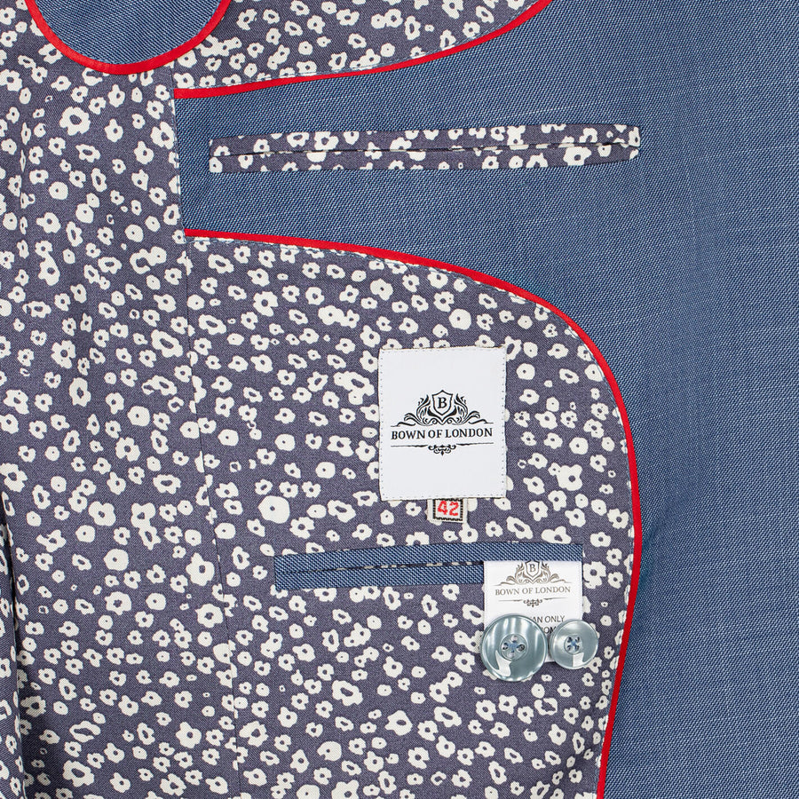 Close-up of a blue suit with floral pocket square and 'Bown of London' label.