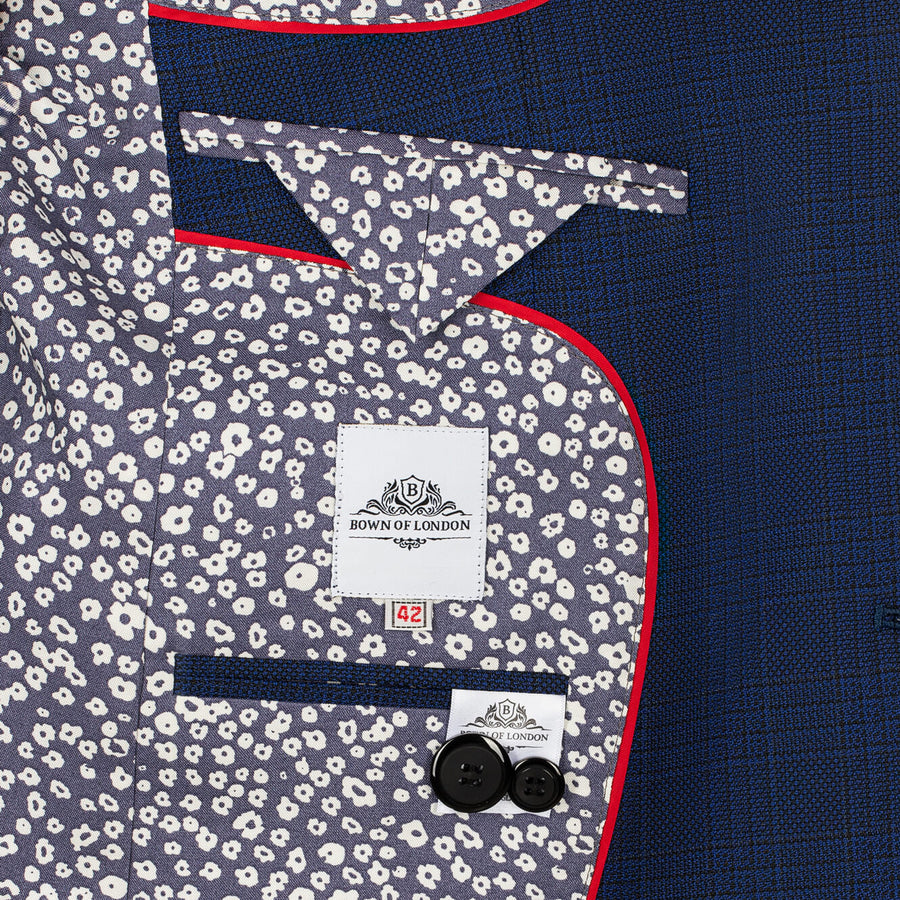Close-up of a suit with floral pocket square and 'Bown of London' label.