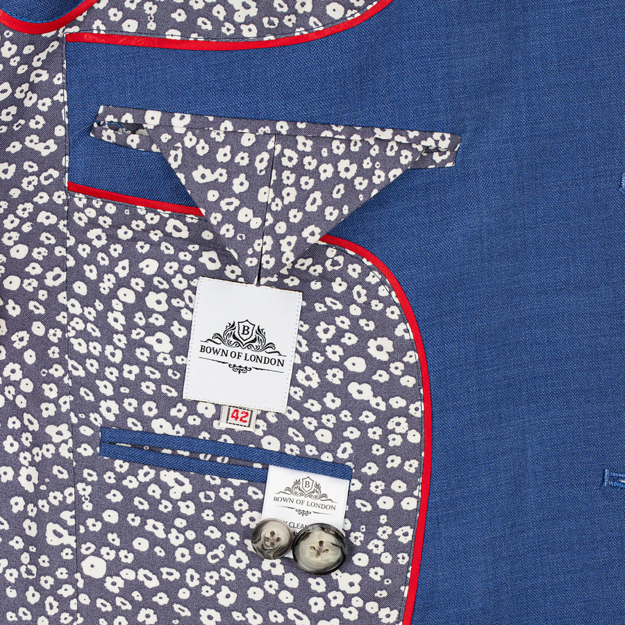 Close-up of a shirt with floral pattern and blue body, featuring a brand label.