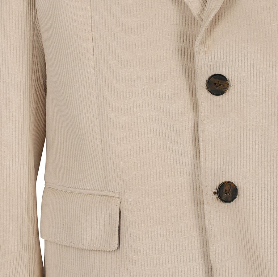 Close-up of a beige corduroy jacket with buttons and a pocket on a beige background