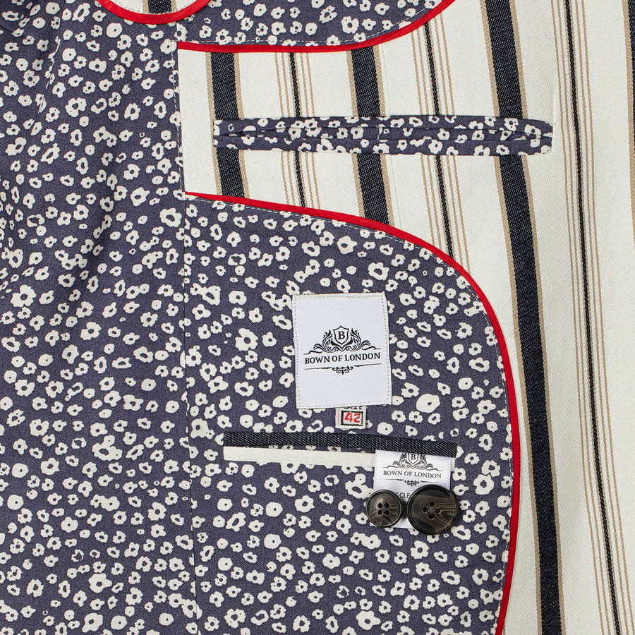 Navy blue blazer with white floral pattern, red trim, and 'Bown of London' label.