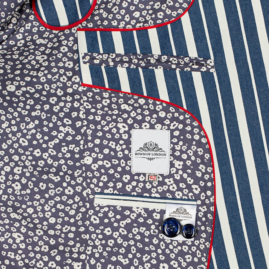 Close-up of a patterned shirt with a brand label on a blue and white striped background