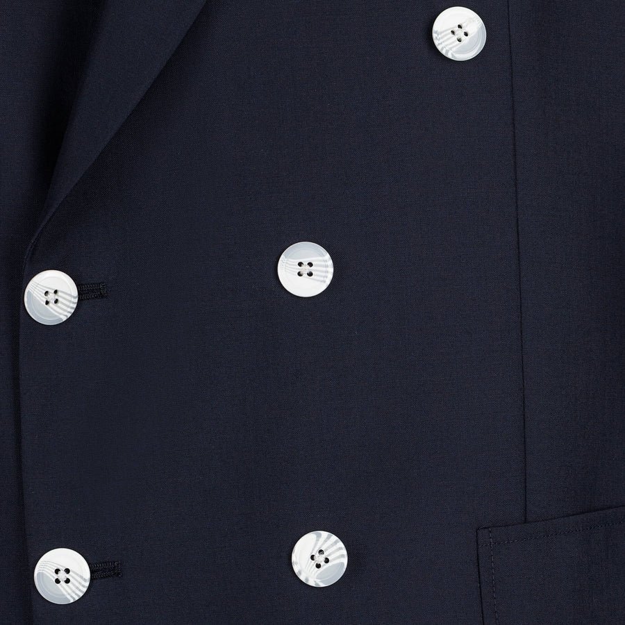 Close-up of a navy blue coat with white buttons