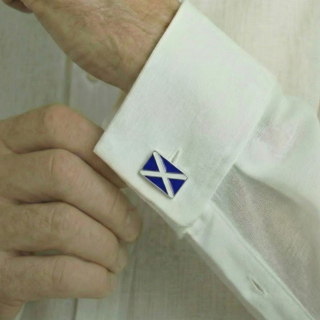 Cufflink with Scottish Flagon a white shirt cuff.