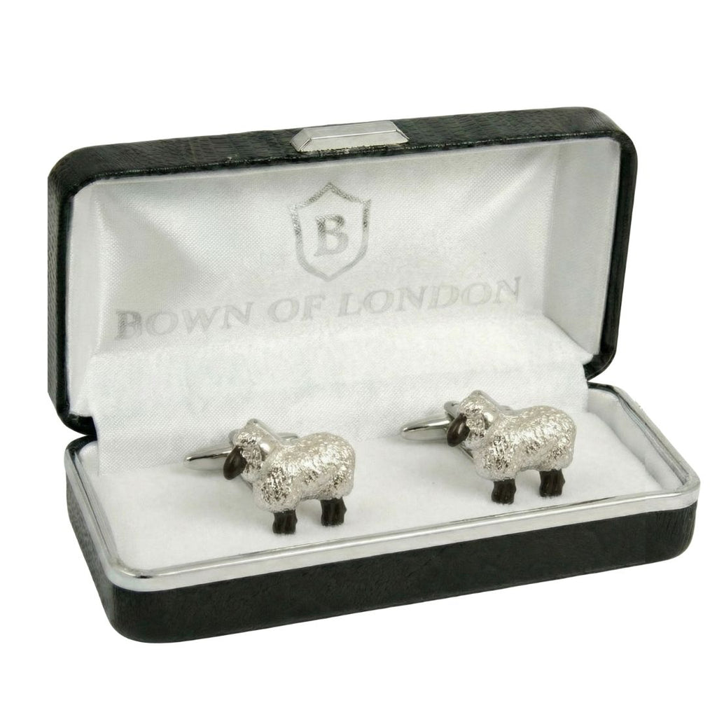 Cufflink shaped like a sheep on a white shirt cuff. Bown of London