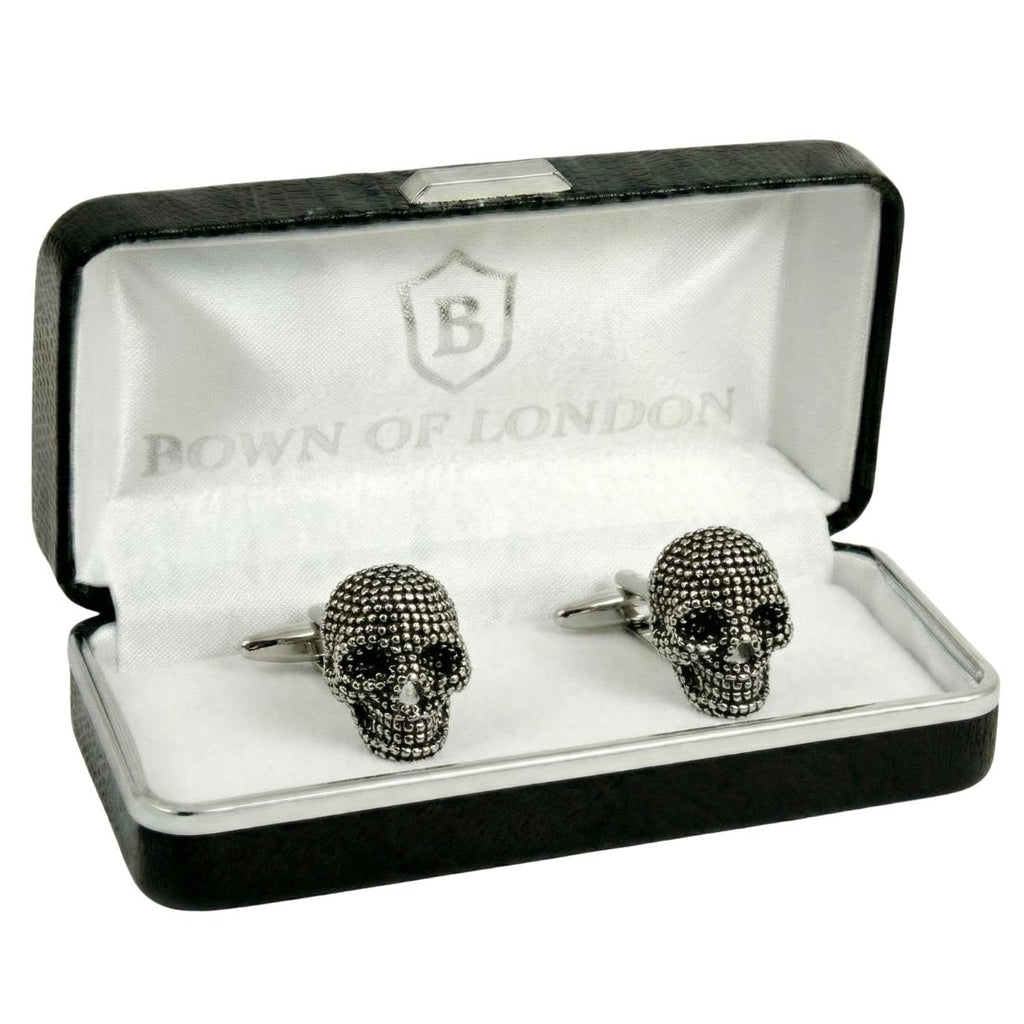 Skull-shaped cufflinks in a 'Bown of London' box. Bown of London.