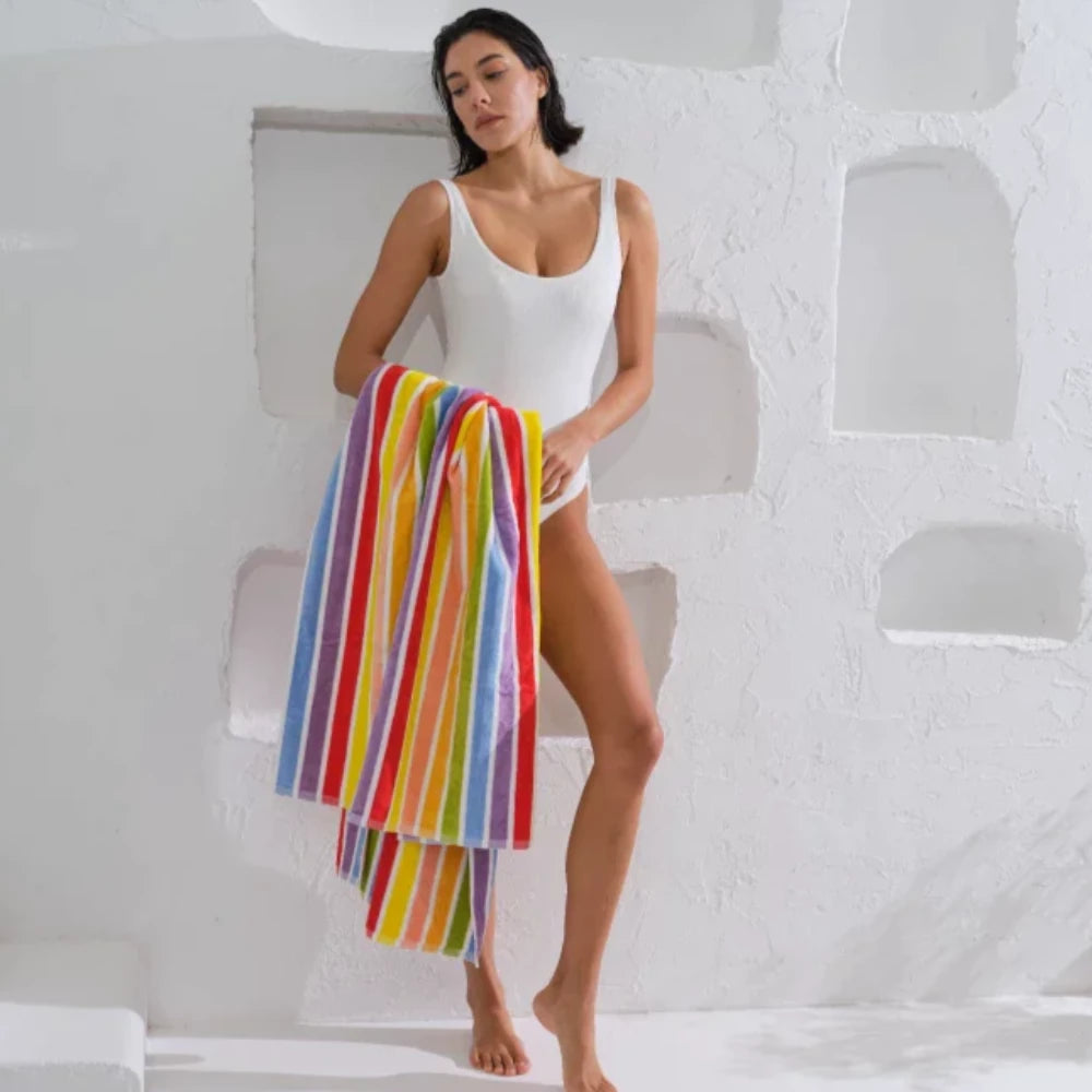 Stand out from the crowd with our vibrant Multicolour Rainbow beach towel. Made from 100% cotton, these towels are soft, eco-friendly, and perfect for a day at the beach.