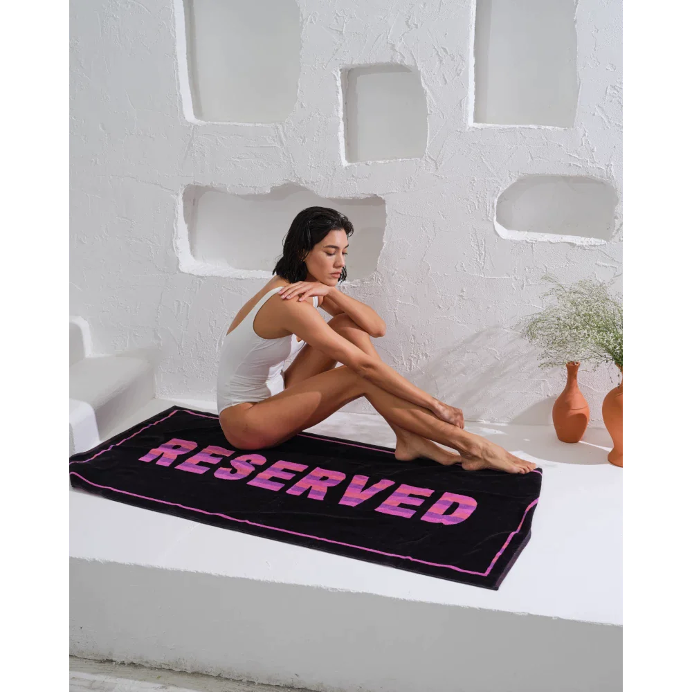 Make a statement at the beach with this unique "Reserved" towel.