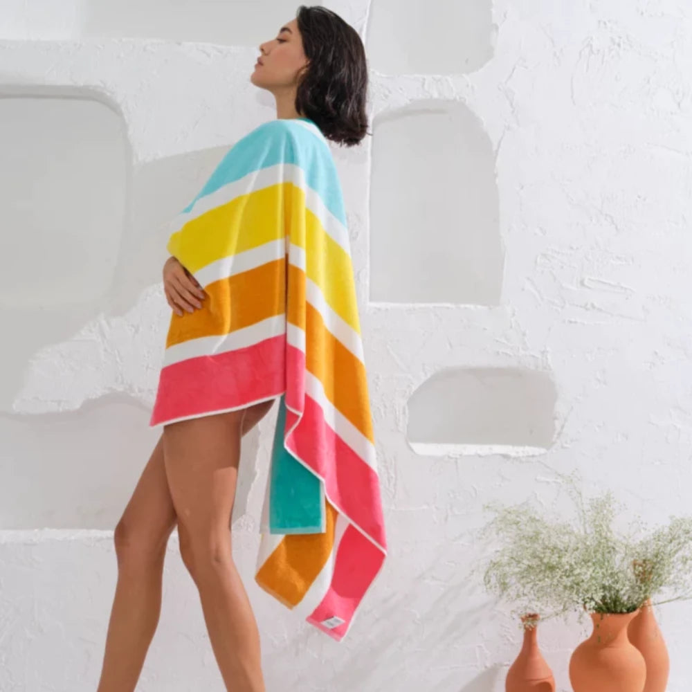 This colorful striped towel is perfect for beach adventures.